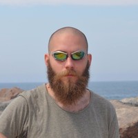 Photo of Casimiro Ferreira , smiling, man, buzzed head, long red beard